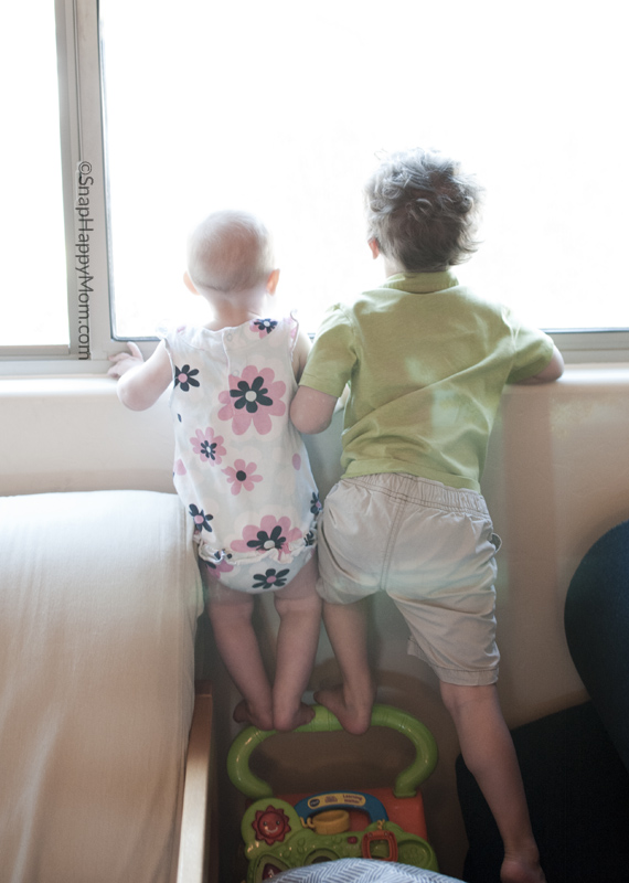 two kids looking out window