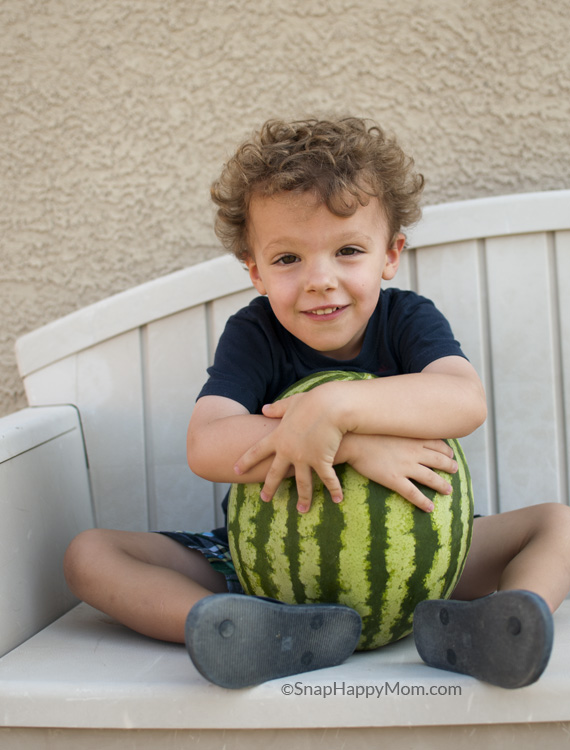 boy hugging watermelon