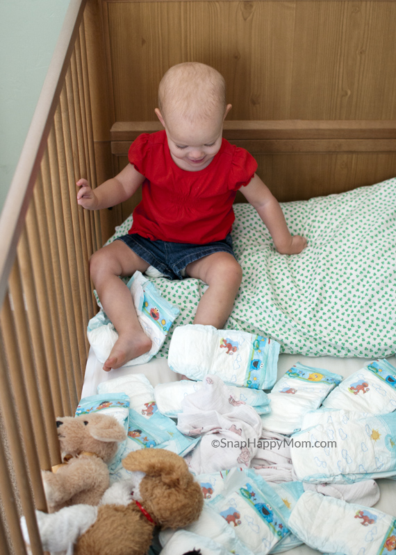 baby girl in crib with diapers